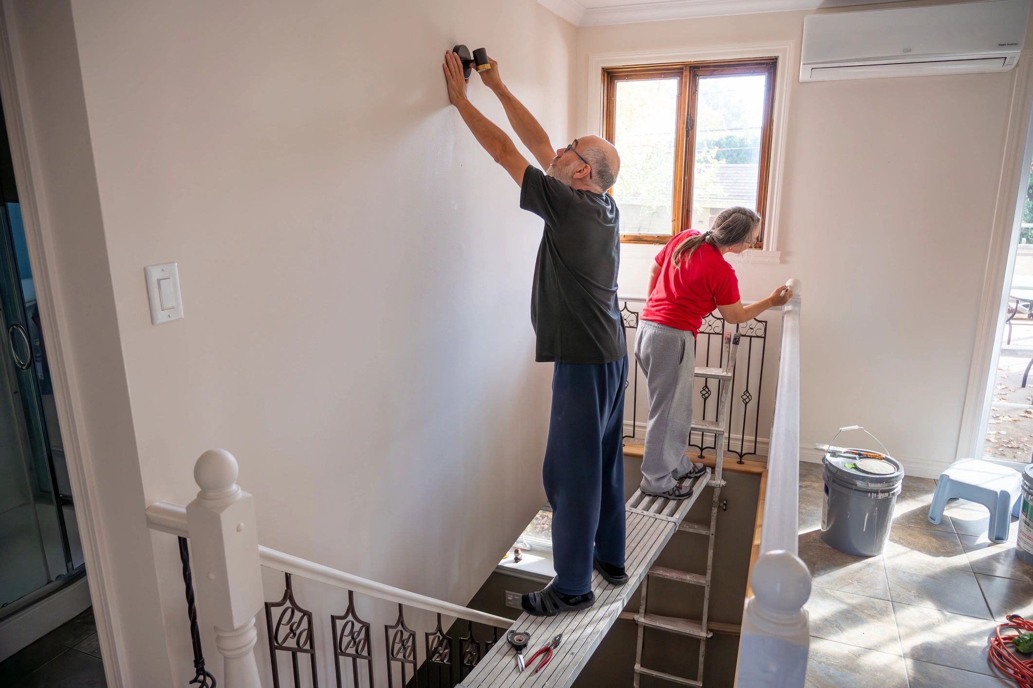 Technician installing equipment on a wall